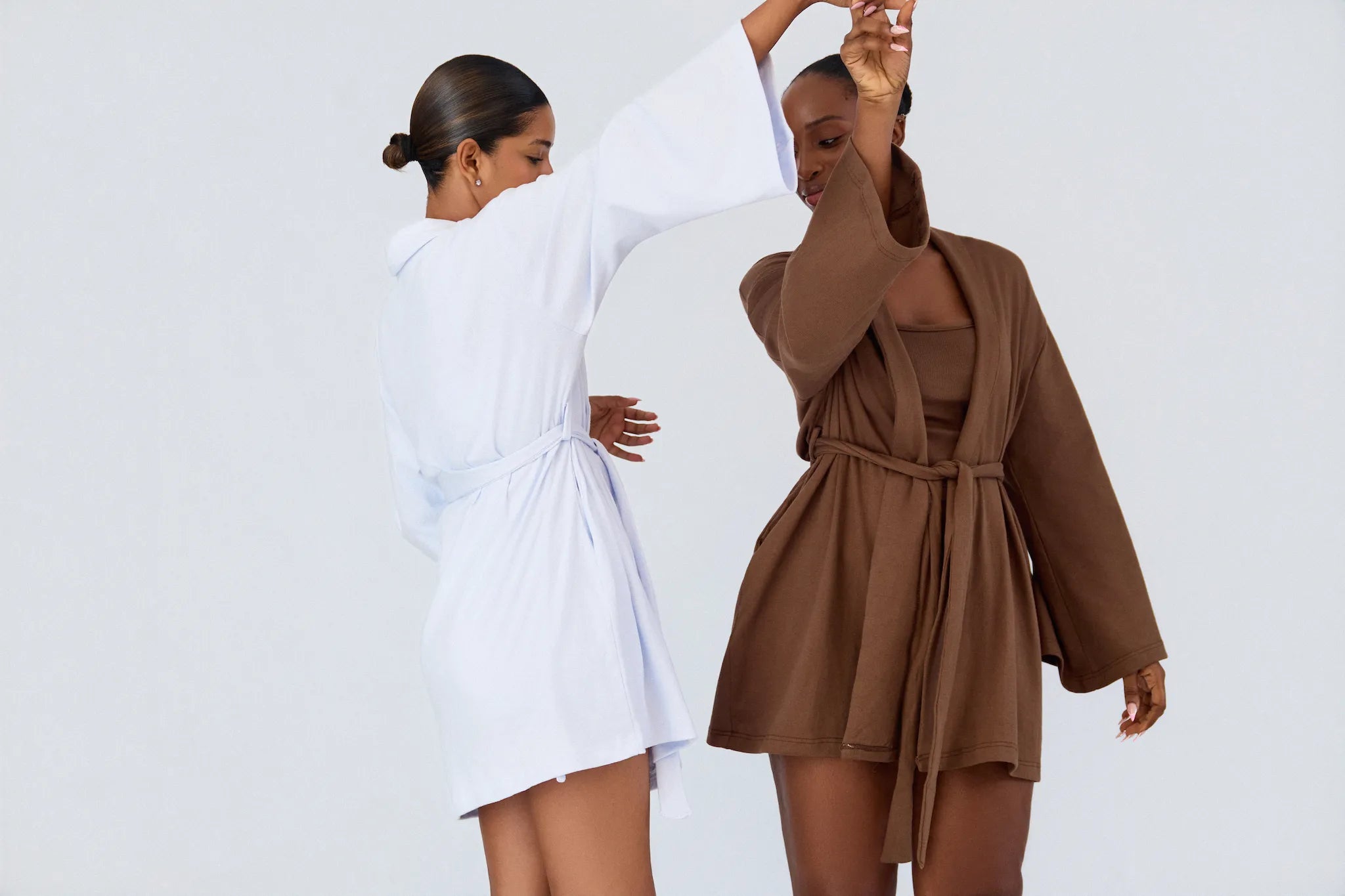 Two models wearing K|KASA Soft & Cozy layered set pajamas in Sky Blue and Chocolate Brown. Matching loungewear sets from the latest restock.